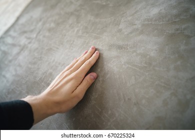 Young Man Hand Touching Concrete Wall