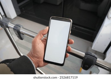 young man hand using smart phone with green screen inside of metro train - Powered by Shutterstock