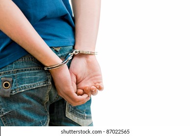 Young Man In Handcuffs. Rear View