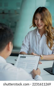 Young man handing resume to employer for job interview to review job application The concept shows the company's ability to agree on job positions, employees. - Shutterstock ID 2231611269