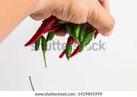 Young man hands take red chilli on white background for cooking., food concept., Top view