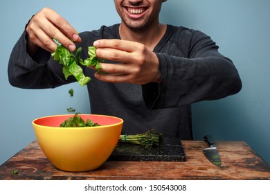 Young man is a happy salad tosser