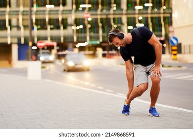 Young man has a ankle injury during walking in the city - Shutterstock ID 2149868591