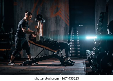young man has workout with personal trainer in modern gym - Shutterstock ID 1674435823