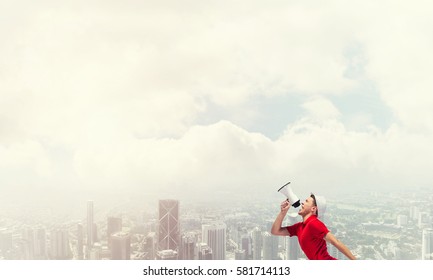 Young Man In Hat Making Announcement In Megaphone