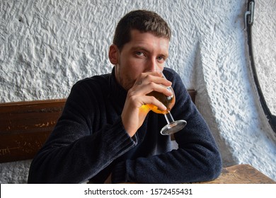 Young Man Having Beers In The Afternoon In A Bar Inside A Cave In Autumn