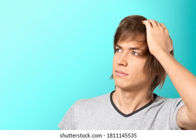 Young man having doubts and with confusing face expression looking to the side