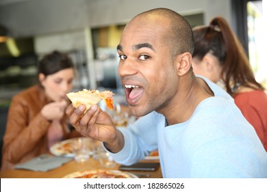 Young Man Having Eating Pizza Slice 