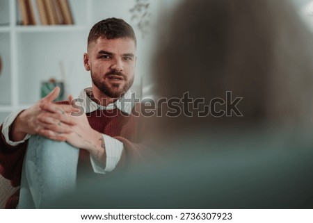 Young man having an engaging conversation during a counseling session, receiving emotional support and mental health care