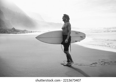 Young Man Having Fun On The Beach After Surf Session - Focus On Face - Black And White Editing.