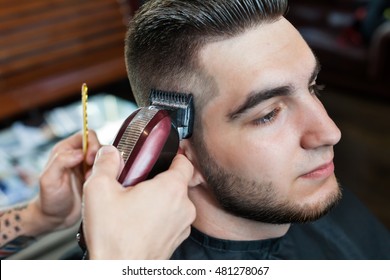 Young man having hair cutted