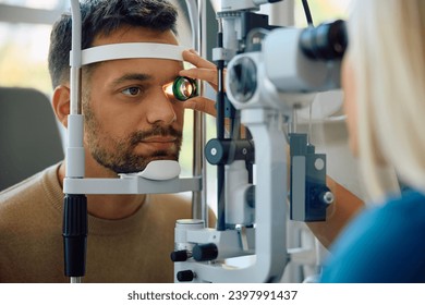 Young man having his eyes checked during a visit at oculist's office. - Powered by Shutterstock