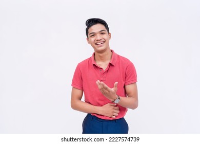 A young man having a lighthearted discussion. Gesturing with his hand. A friendly guy explaining a topic in a easygoing way. Isolated on a white backdrop. - Shutterstock ID 2227574739