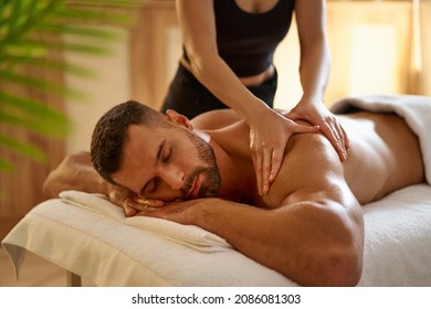 Young man having a massage by a professional masseuse                               