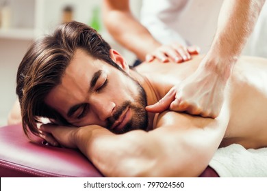 Young man is having massage on spa treatment.