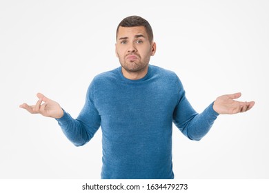 Young Man Having No Idea Holding Hands Up Isolated On White Background
