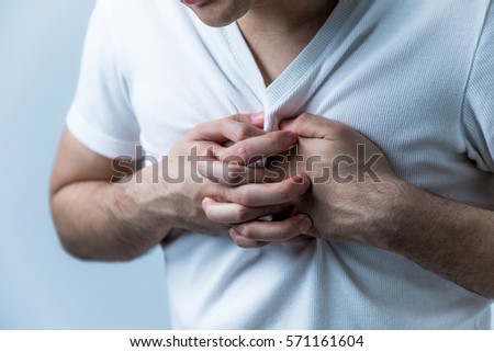 young man having a pain in his breast