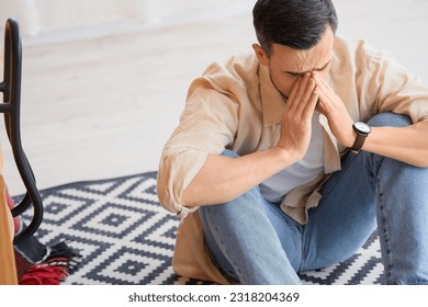 Young man having panic attack in office