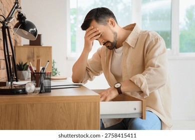 Young man having panic attack in office