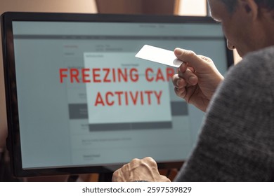 Young man having problems with online card payment, closeup photo. Man frustrated, staring at computer monitor with account freeze and blocking alert