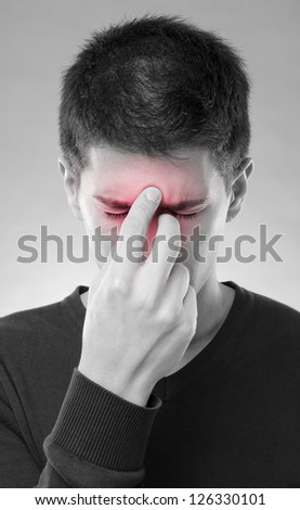 Young man having trouble with sinus pain