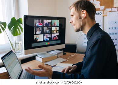 Young man having video call via computer in the home office. Stay at home and work from home concept during Coronavirus pandemic. Virtual house party  - Powered by Shutterstock