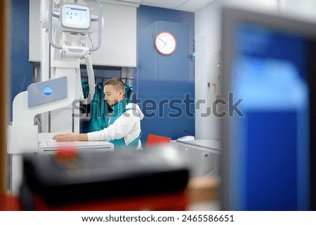 Similar – Image, Stock Photo Young man having x-ray shot of broken hand in x ray room in modern clinic. Patient wearing in protect lead apron