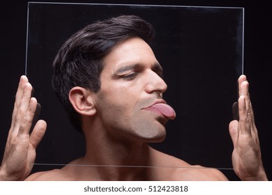 Young Man Head Face Pressed Against Glass, Hands Holding It.