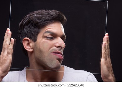 Young Man Head Face Pressed Against Glass, Hands Holding It.