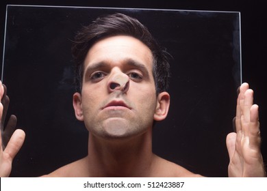 Young Man Head Face Pressed Against Glass, Hands Holding It.