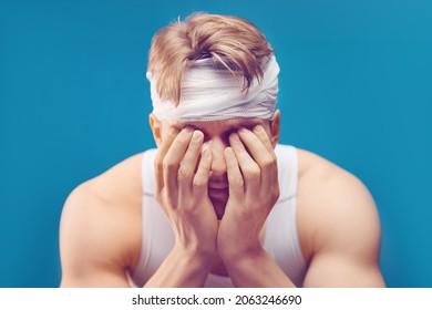 Young Man With Head Injury In The Doctor's Office. Head Bandaged With A Bandage