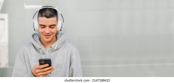 Young Man With Headphones And Mobile Phone