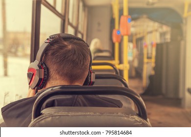 young man in headphones in a tram - Powered by Shutterstock