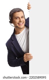 Young Man With A Headset Standing Behind A Blan White Board Isolated On White Background