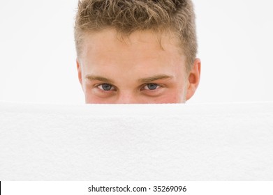 Young Man Hiding Himself Behind A White Towel