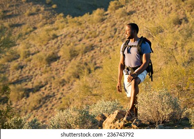 Young Man Hiking Outdoors On A Trail At Phoenix Sonoran Preserve In Phoenix, Arizona.