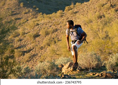 Young Man Hiking Outdoors On A Trail At Phoenix Sonoran Preserve In Phoenix, Arizona.