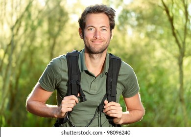 Young Man Hiking Smiling Happy Portrait. Male Hiker Walking In Forest.