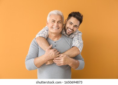 Young man and his father on color background - Powered by Shutterstock