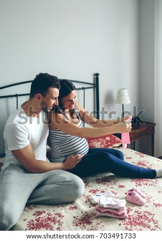 Image, Stock Photo Man and pregnant woman looking baby clothes