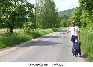 Young Man Is Hitchhiking In The Middle Of Nowhere In Eighties.