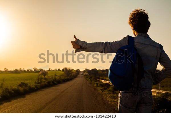 Young Man Hitchhiking\
on a Country Road