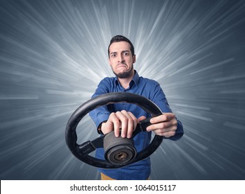 Young man holding black steering wheel with white lines behind him 