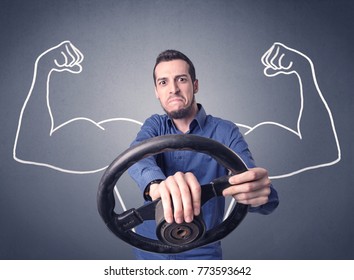Young man holding black steering wheel with muscly arms drawn next to him