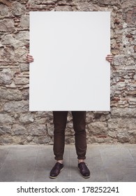 Young Man Holding Blank Poster