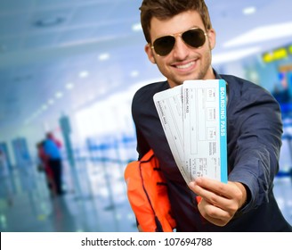 Young Man Holding Boarding Pass, Indoor