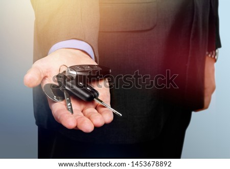 Young man holding car keys close-up
