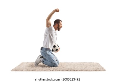 Young man holding a football, kneeling and cheering isolated on white background
