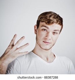 Young  Man Holding Up Four Fingers