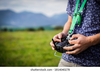 Young man is holding a FPV drone remote controller in his hand.